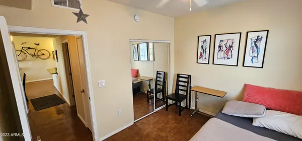 a view of a hallway with workspace and a couch