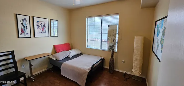 a bedroom with a bed and wooden floor