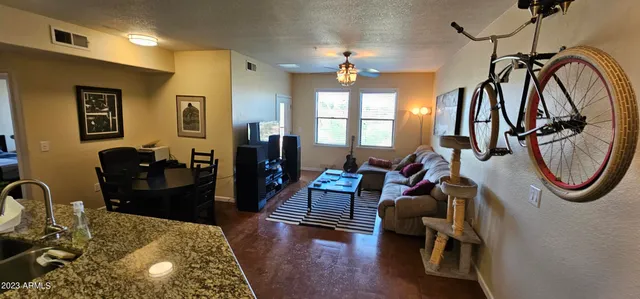 a living room with furniture and a chandelier