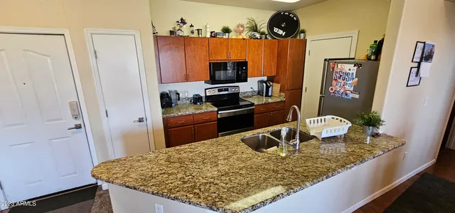 a kitchen with a sink a stove and refrigerator