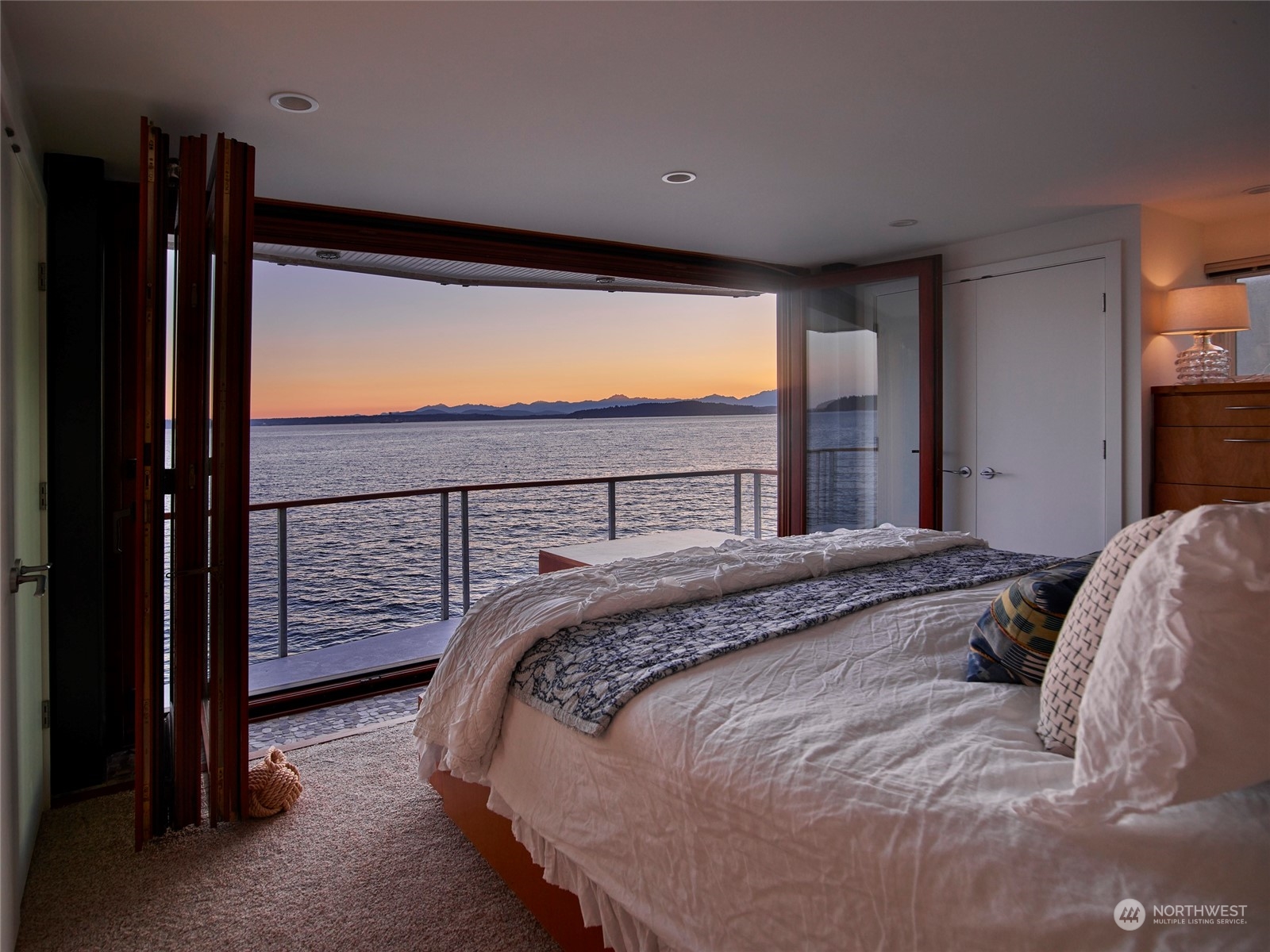 4141 Beach Drive Southwest Seattle, WA 98116 - Photo 17 of 31 a bed sitting in a bedroom next to a window