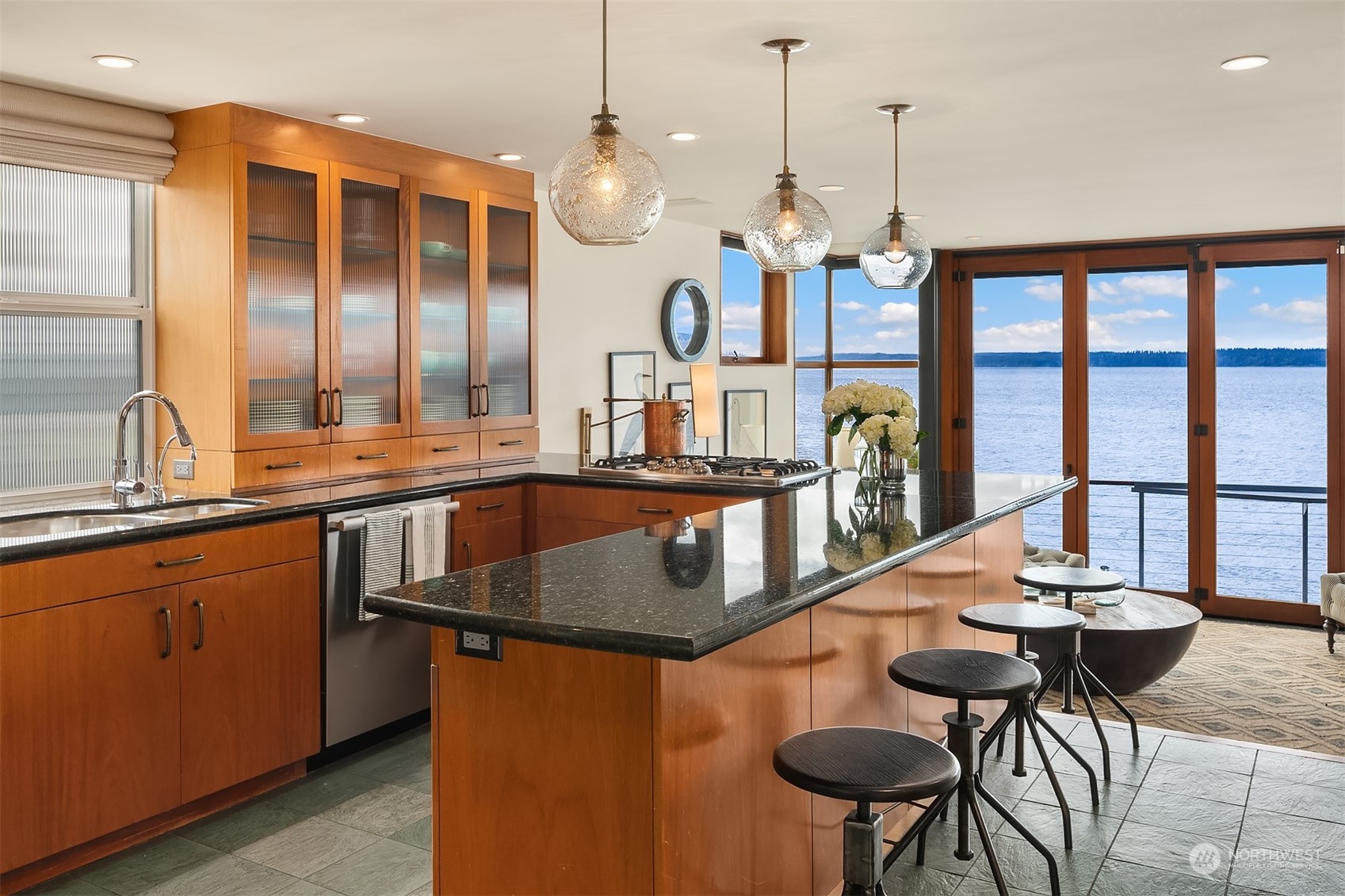 4141 Beach Drive Southwest Seattle, WA 98116 - Photo 7 of 31 a kitchen with stainless steel appliances granite countertop a kitchen island a stove and a sink