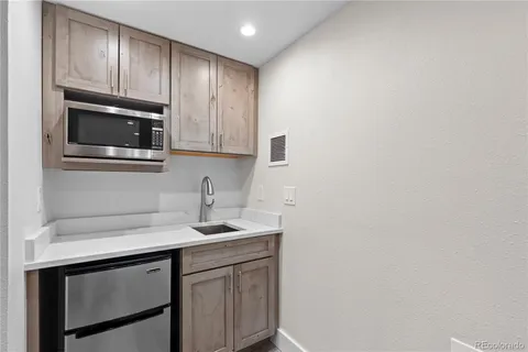 a kitchen with a sink cabinets and microwave