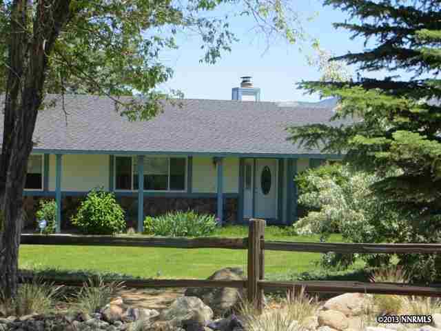 12930 Fellowship Way Reno, NV 89511 - Photo 1 of 1 a front view of a house with a yard and potted plants