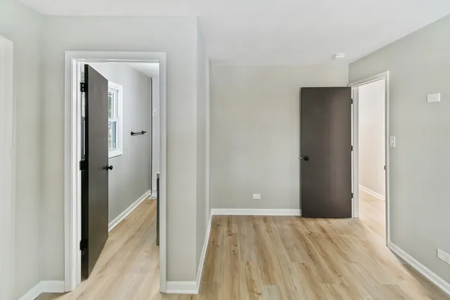 a view of hallway with wooden floor