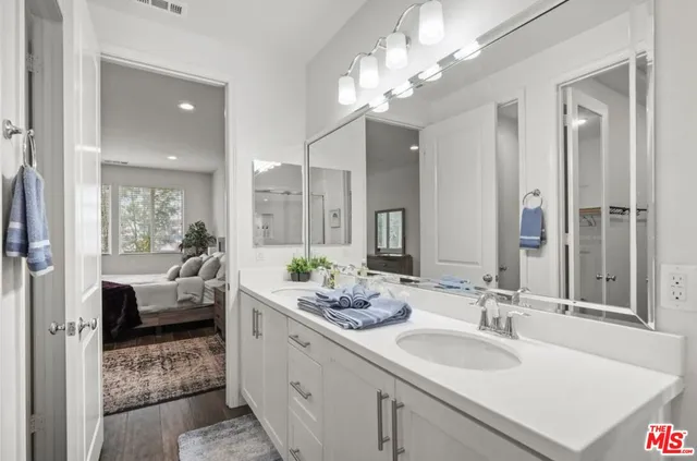a en suite bathroom with double sink and a mirror