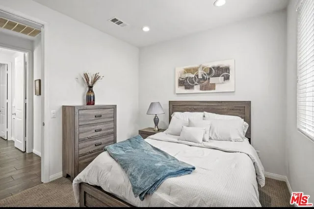 a bedroom with a bed and a dresser