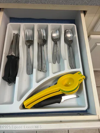 a bed sitting in a spacious bedroom next to a window