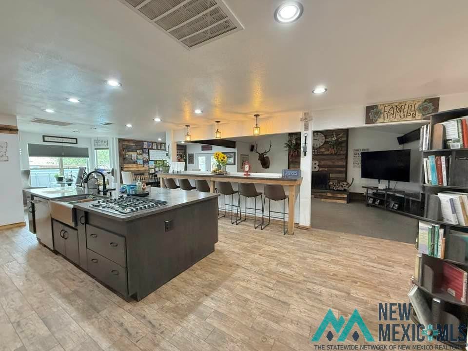 5404 Sioux Road Carlsbad, NM 88220 - Photo 32 of 100 Spacious kitchen island featuring an integrated farmhouse sink and gas cooktop