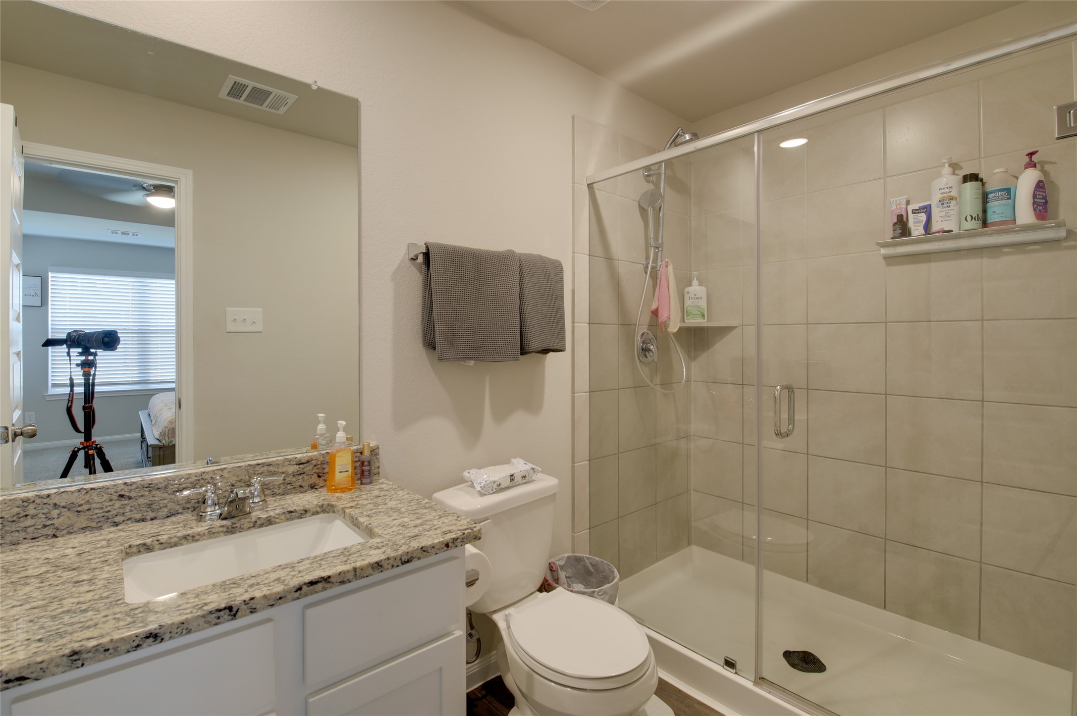14026 Chinook Drive Conroe, TX 77384 - Photo 21 of 34 a bathroom with a granite countertop sink a toilet and shower