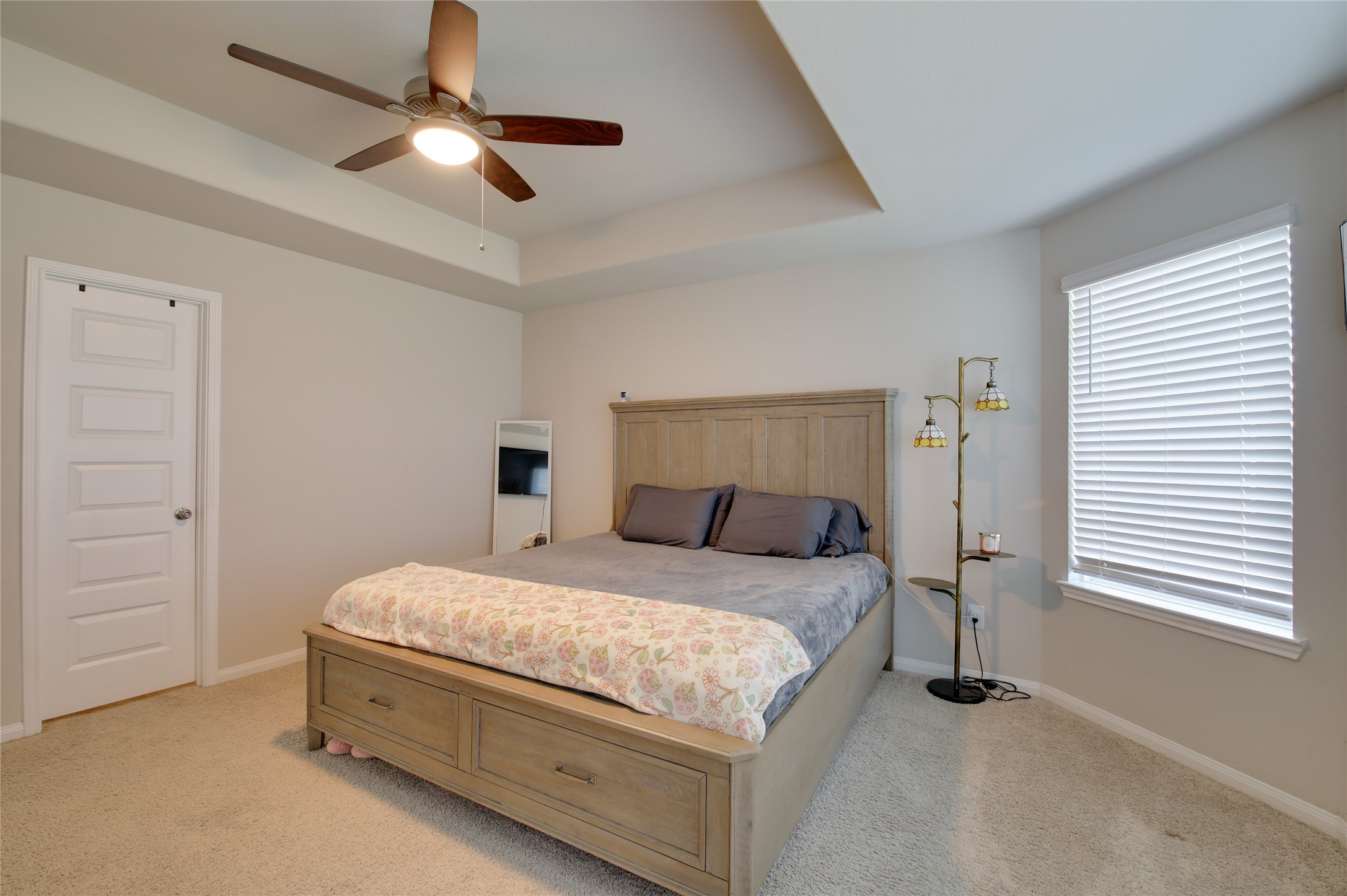 14026 Chinook Drive Conroe, TX 77384 - Photo 22 of 34 a bedroom with a bed and a ceiling fan