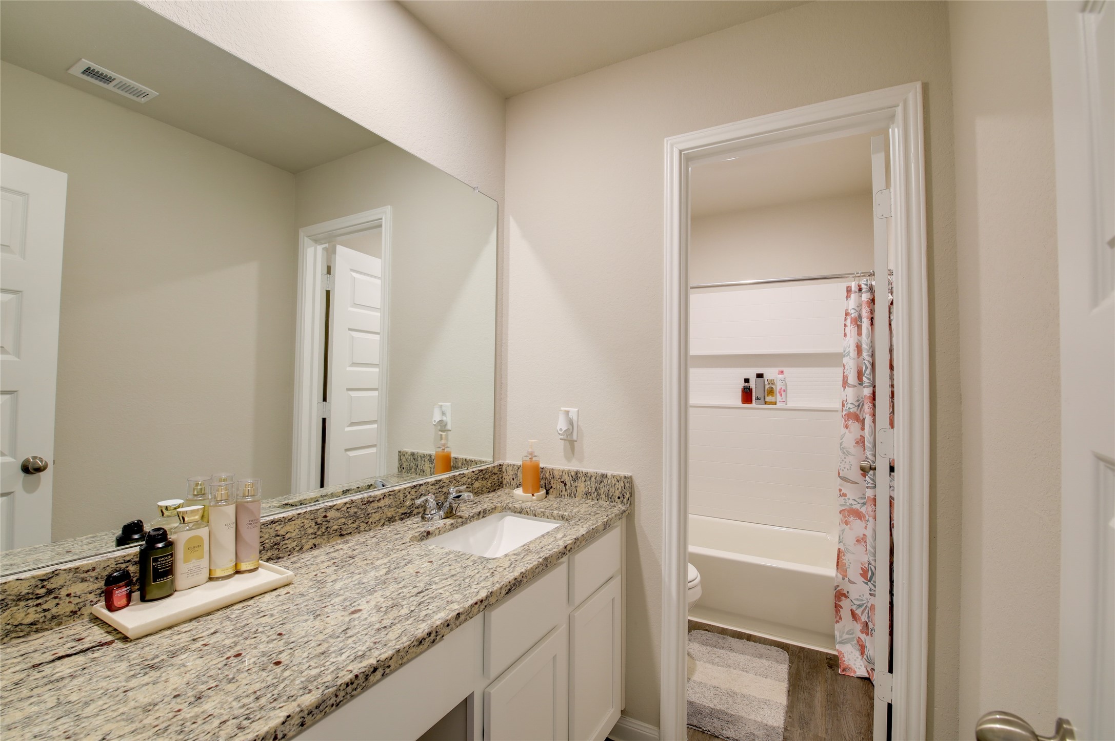 14026 Chinook Drive Conroe, TX 77384 - Photo 23 of 34 a bathroom with a granite countertop sink and a mirror