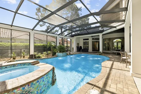 an aerial view of a house with yard and outdoor seating