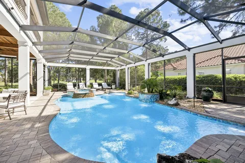 an aerial view of a house with a garden and swimming pool