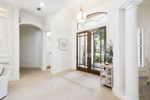 a large kitchen with kitchen island a large window