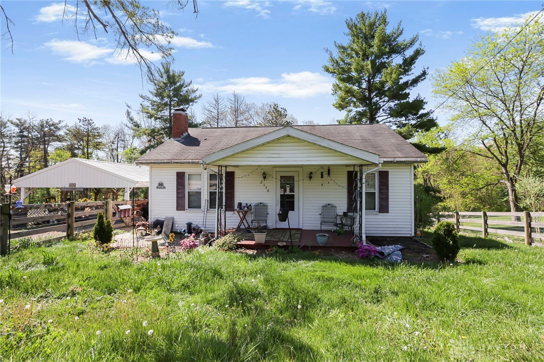 2390 Ridge Road Zanesville, OH 43701 - Photo 2 of 45 This charming home offers a welcoming facade with a cozy porch, perfect for enjoying peaceful moments.