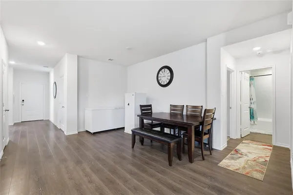 a view of a workspace with furniture and wooden floor