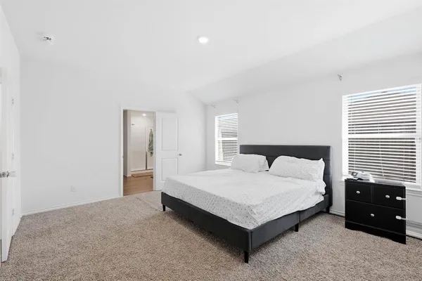 a large bedroom with a bed and a closet