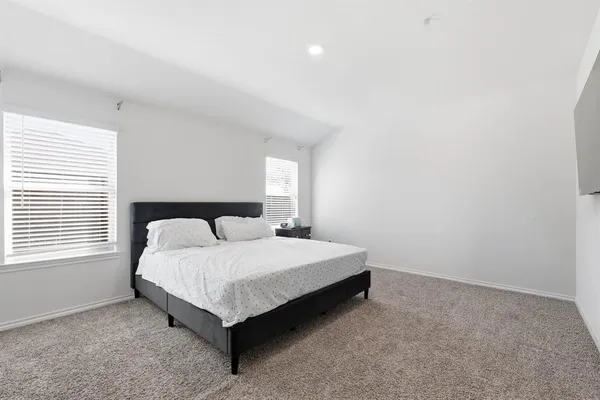 a bedroom with a bed lamp and window