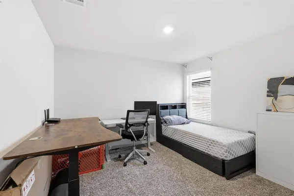 a bedroom with a bed and a table in it