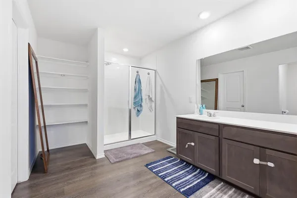 a bathroom with a double vanity sink and mirror