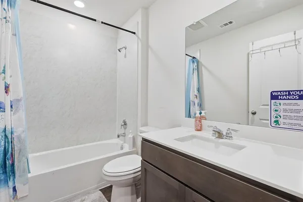 a bathroom with a sink a toilet and a bathtub