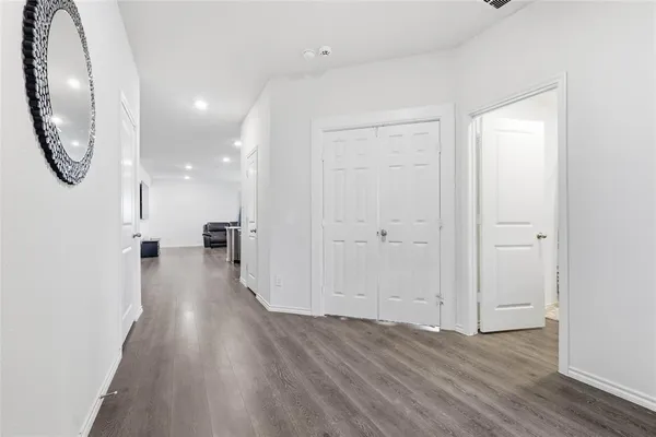 a view of a room with wooden floor and white doors