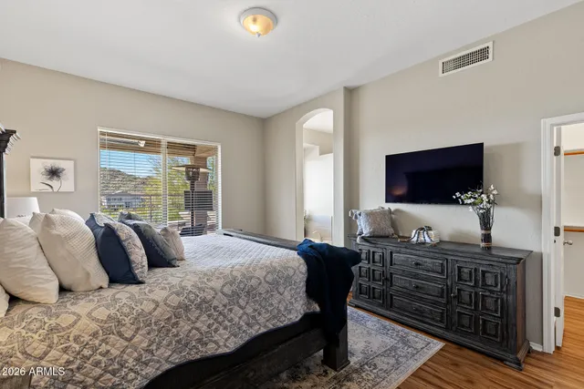 a bedroom with a bed and a flat screen tv