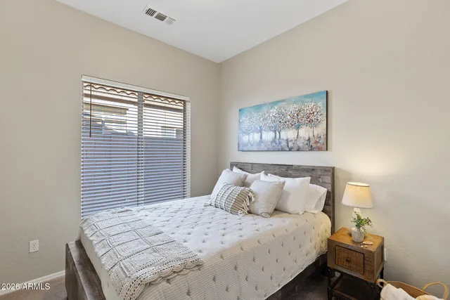 a bedroom with a bed and a window