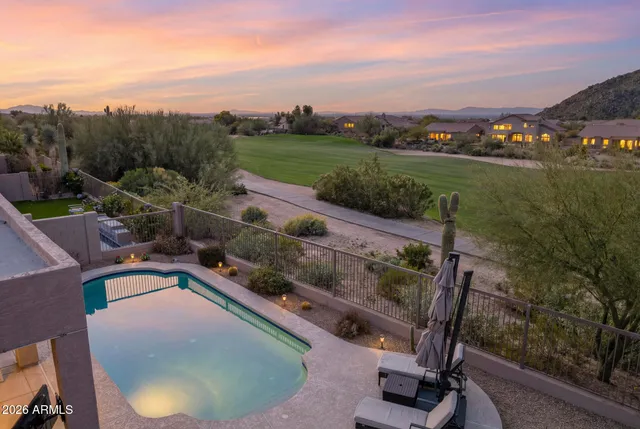 a view of a swimming pool with a patio and a garden