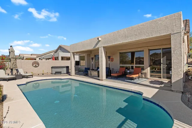 a swimming pool with outdoor seating and yard