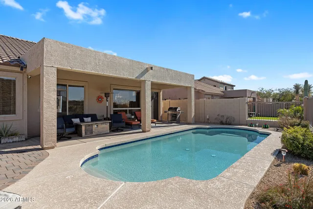 a view of a house with backyard porch and sitting area