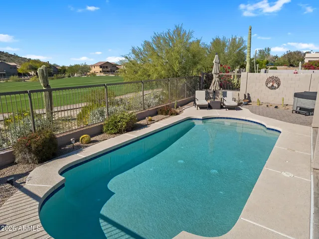a view of a swimming pool with a lounge chair