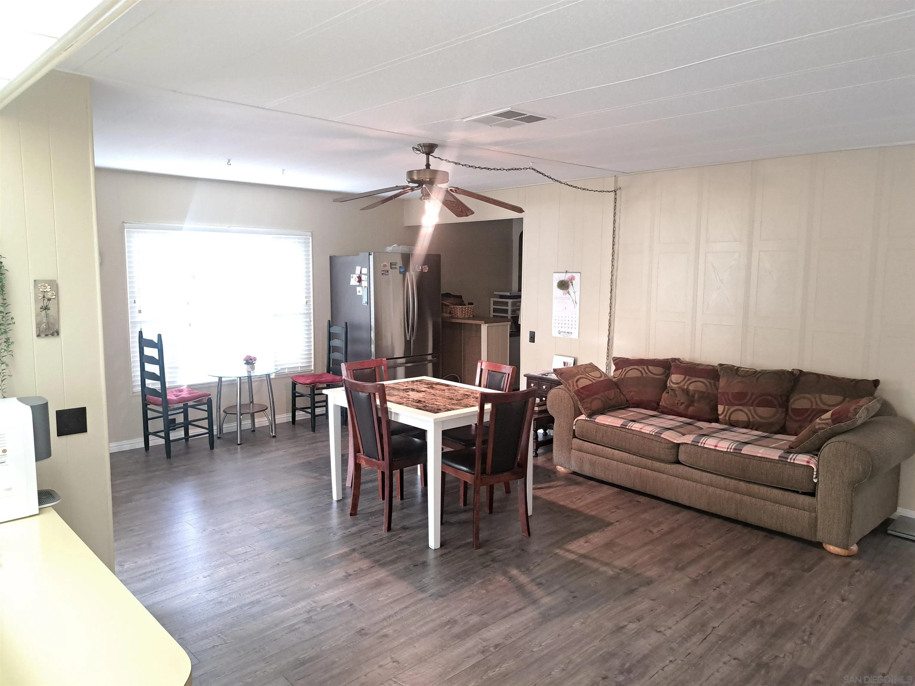 4650 Dulin Road, Unit 12 Fallbrook, CA 92003 - Photo 14 of 36 a living room with furniture a wooden floor and a dining table