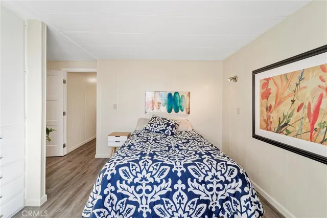 a bed sitting in a bedroom next to a window