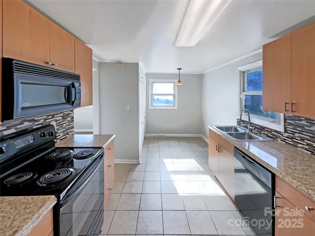 a kitchen with a stove a microwave and wooden cabinets