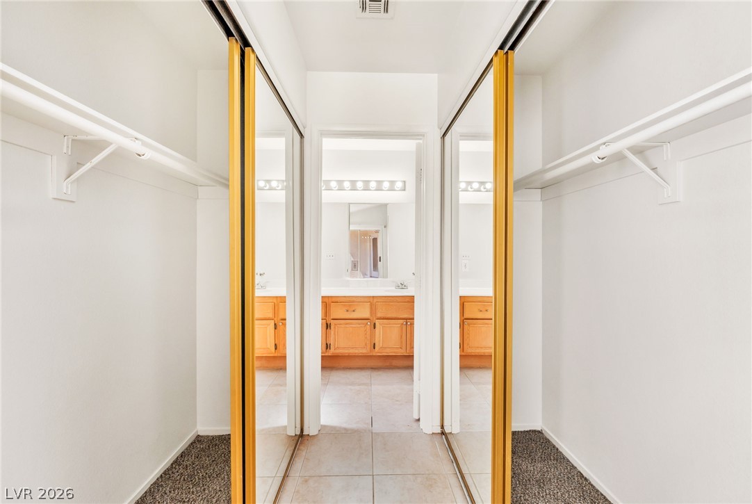 4904 Spring Falls Way North Las Vegas, NV 89031 - Photo 15 of 24 Mirrored closet doors offer both convenience and visual appeal to this well-organized space.