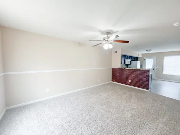 a view of a windows and chandelier fan in a room