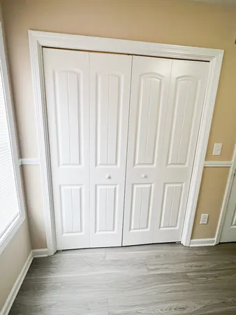 a view of a door with wooden floor