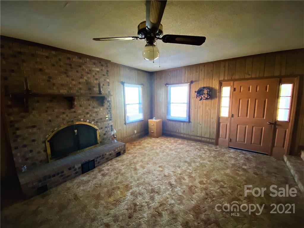 71 Mclendon Road Morven, NC 28119 - Photo 11 of 21 a living room with furniture and a fireplace