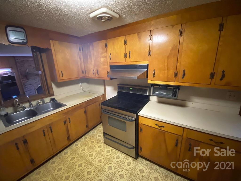 71 Mclendon Road Morven, NC 28119 - Photo 15 of 21 a kitchen with sink cabinets and a table
