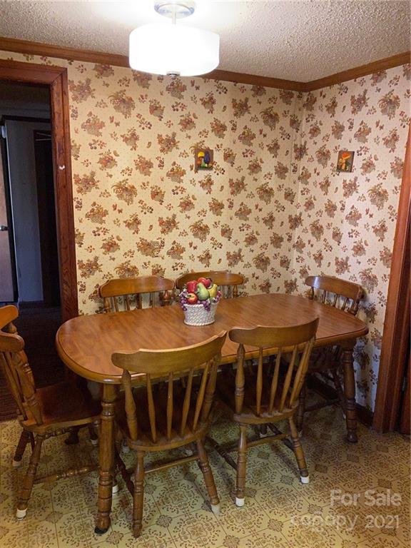 71 Mclendon Road Morven, NC 28119 - Photo 17 of 21 a view of a dining room with furniture and wooden floor