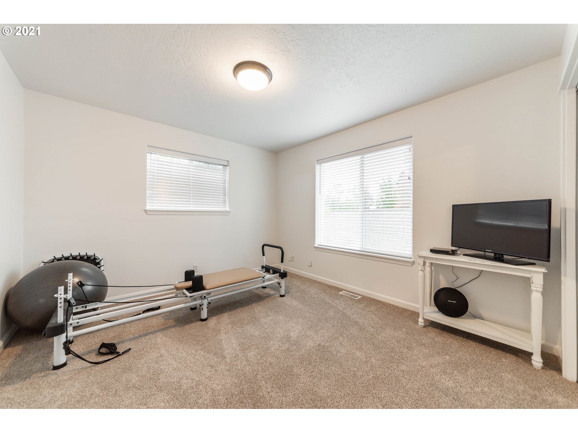 678 63rd Street Springfield, OR 97478 - Photo 22 of 32 a room with gym equipment and flat screen tv