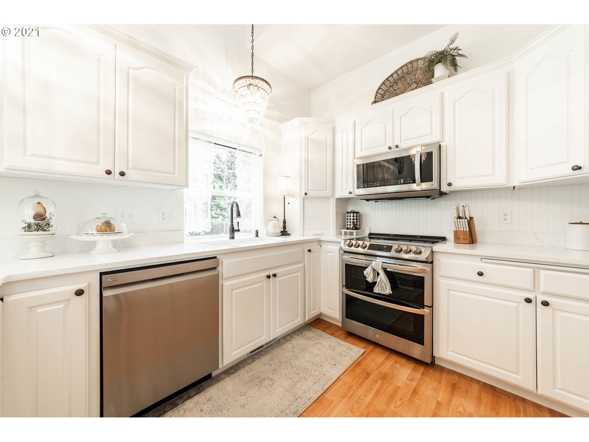 678 63rd Street Springfield, OR 97478 - Photo 10 of 32 a kitchen with stainless steel appliances white cabinets a sink and a stove
