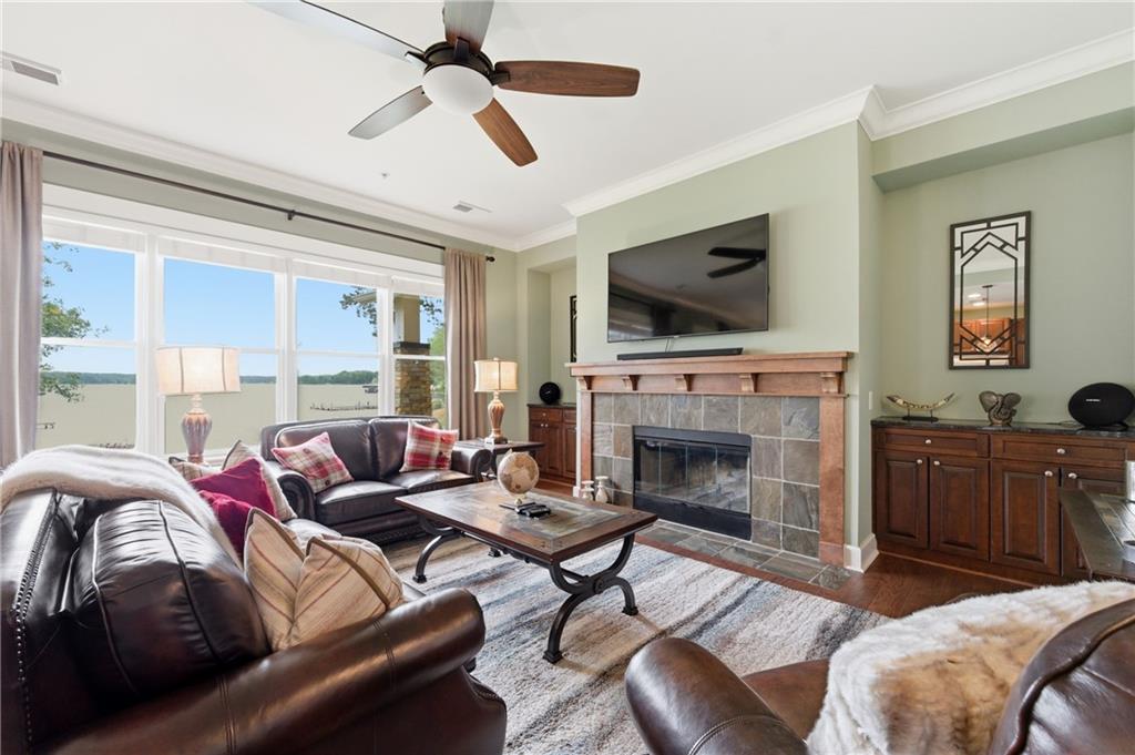 117 South Bay Road, Unit 402 Eatonton, GA 31024 - Photo 24 of 48 a living room with furniture a flat screen tv and a fireplace