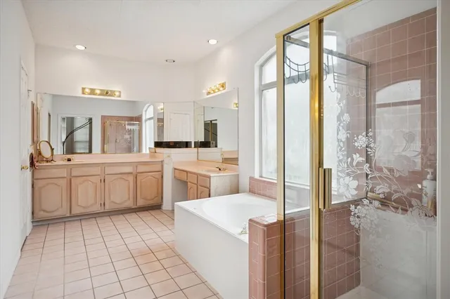 a large white kitchen with cabinets a sink a counter top space and stainless steel appliances