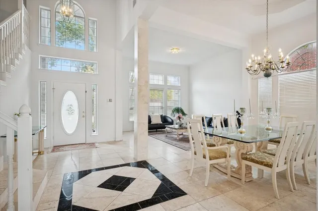 a living room with furniture a chandelier and a window