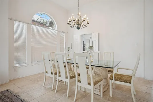 a dining room with furniture and chandelier