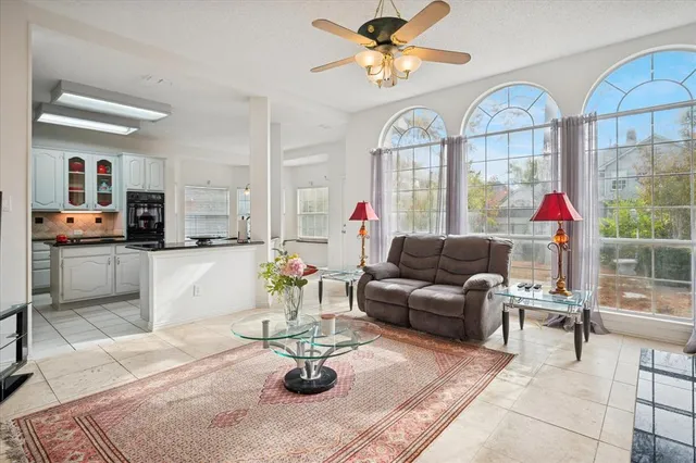 a living room with furniture a fireplace and a large window