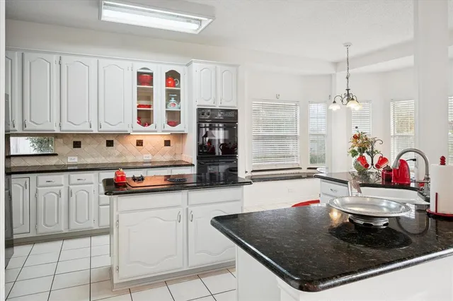 a kitchen with stainless steel appliances granite countertop a sink and cabinets